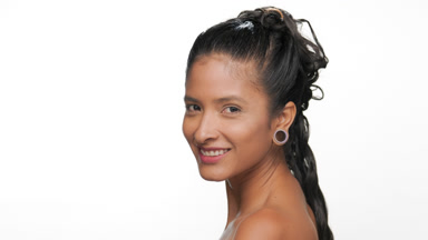 South american woman with tan firm skin turns to camera