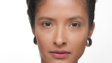 Honey skinned argentine woman presents matte skin for face care
