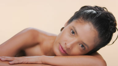 Beautiful hispanic woman nourished caramel skin leans on forearm