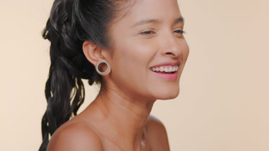 Argentine woman with light brown skin looks through magnifier