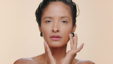 South american woman matte caramel skin strokes face beige bg