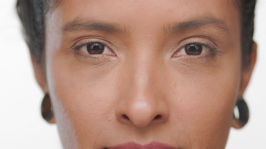 Latin woman light brown complexion opens eyes matte skin concept