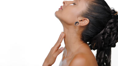 South american woman touches throat for firm skin on white bg