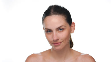 Fair-skinned freckled latin woman gazes at camera on white bg