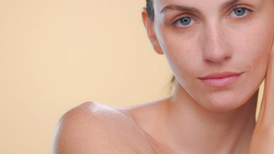 Fair-skinned freckled spanish woman shows skin elasticity