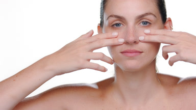 Caucasian latina with freckles strokes under-eye firm skin