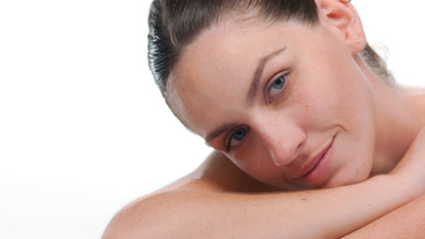Fair-skinned latina with freckles lifts head off forearm white