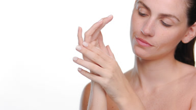 Light-complexioned latina with freckles caresses hands white