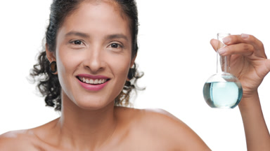 Curly latina model shows small blue flask off-shoulder look
