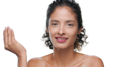 Latin american woman with natural curls uses cotton pad white