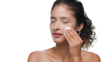 Dark-haired beauty shows easy makeup removal with cotton round