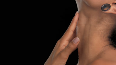Light brown-skinned woman in profile gently touches throat black