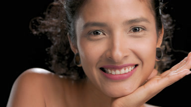 Off-shoulder hispanic woman props chin smiles at camera black