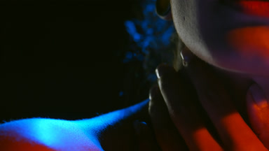 Young woman in blue and red led light strokes shoulder black bg
