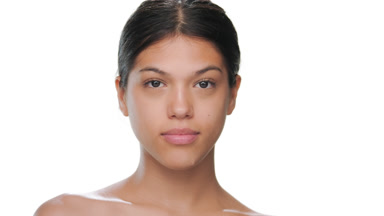 Brunette model opens eyes looks at camera healthy skin