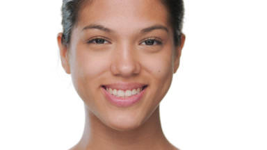 Happy beauty model smiles for camera presenting matte skin