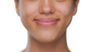 Youthful beauty smiles highlighting her healthy lips