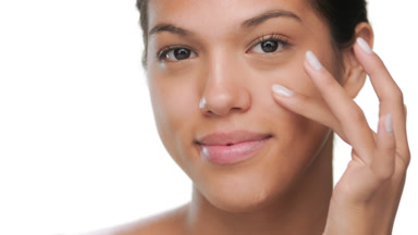 Teenage model touches cheek under eye soft skin
