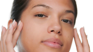 Youthful model touches face with hands clear skin