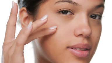 Youthful beauty touches cheek reveals clear skin glow