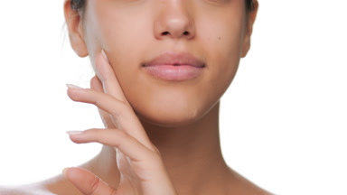 Young woman strokes jawline lips touch face soft skin