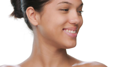 Cosmetics model smiling aside demonstrates healthy skin