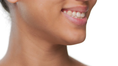 Skincare beauty model smiles showcases healthy lips