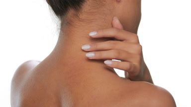 Young woman strokes neck shoulder emphasizes clean skin