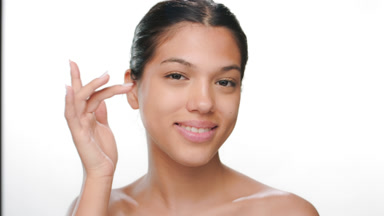 Young model touches under eye smiles shows pure skin