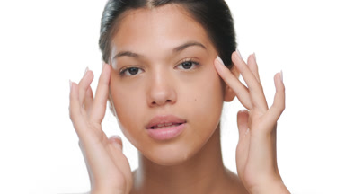 Natural beauty touches face behind wet glass clear skin