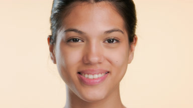 Cosmetic model smiles for camera illustrating fresh skin