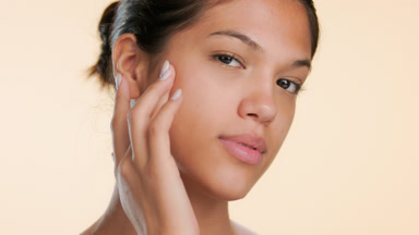 Skincare beauty touches forehead and cheek clear skin