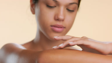 Young female's lips gently touch her forearm skin