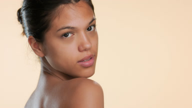 Attractive model looks over shoulder turns walks away