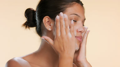 Skincare model washing face with gentle face wash