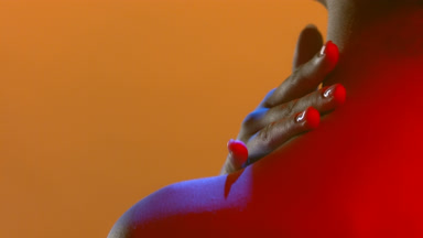 Model in blue red light back to camera strokes nape