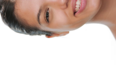 Youthful model smiles for camera revealing clear skin