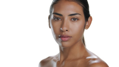 Young Hispanic woman turns, walks away, showing healthy skin