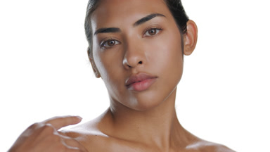 Brunette Hispanic woman stroking decolletage, protected skin