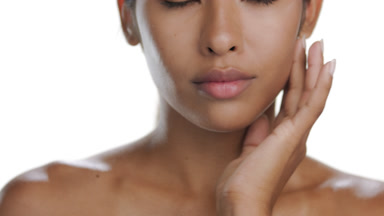 Hispanic model caresses jawline with palm, clear skin focus