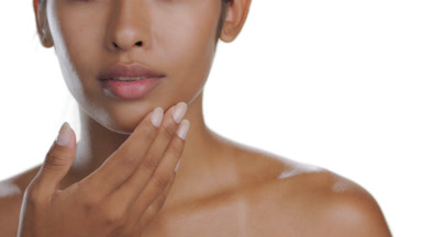 Hispanic brunette strokes cheek upward with palm, soft skin
