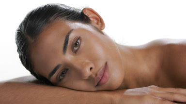 Stylish young Hispanic woman lifts head off forearm, soft skin