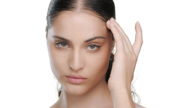 Fair Latina with green eyes slides fingers upward, clear skin