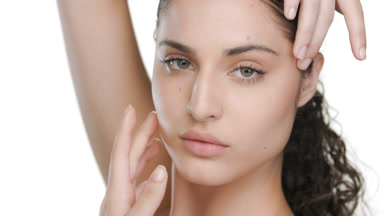 Latin American beauty touches chin, hand over head