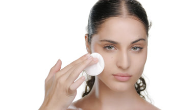 Hispanic model with green eyes wipes cheek
