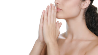 Youthful Latin brunette inhales cosmetics, massaging hands