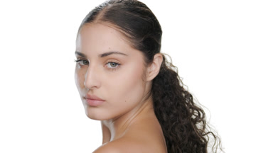 Stylish young Hispanic woman walks away, moisturized skin