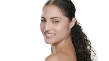 Vibrant young Latin woman smiles, walks away, protected skin