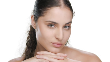 Young Hispanic model props chin with hands