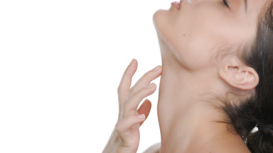 Latina with fair skin gently touches throat, revealing firm skin